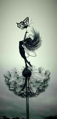 This black and white live wallpaper features a striking image of a woman with a butterfly perched atop a dandelion