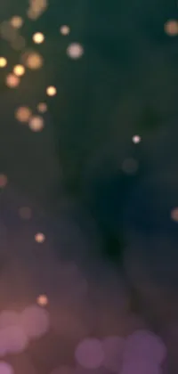 This phone live wallpaper displays a close-up view of a cell phone with a blurry background, along with a stunning digital art image of twinkling stars against a soft lighting gradient