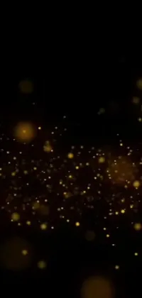 Our phone live wallpaper features a stunning black background with luxurious gold sparkles, bubbles, and wisps, adorned with fireflies that give it an ethereal feel