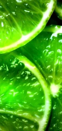 This phone live wallpaper showcases a striking close-up of fresh limes