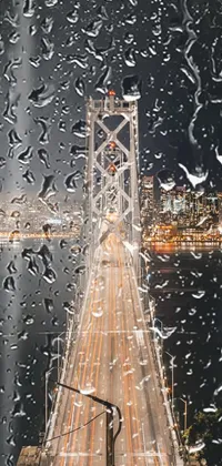 This phone wallpaper features a compelling image of a bridge spanning over water at night in San Francisco