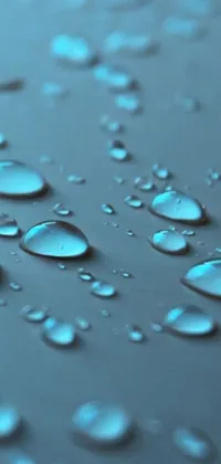 This live wallpaper features a close up of water droplets on a surface