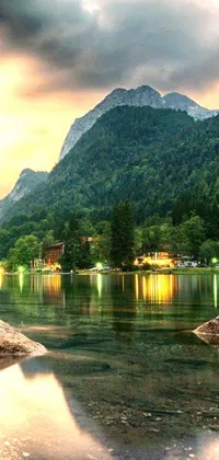 This livel wallpaper showcases a stunning view of a mountain and a small town located near a lake and forest