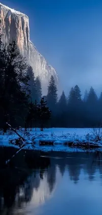 This stunning live wallpaper depicts a mountain standing tall over a tranquil lake in the heart of a dense forest blanketed in snow