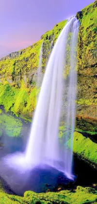 This lush phone live wallpaper features digital rendering of a stunning waterfall in the midst of a vibrant green field