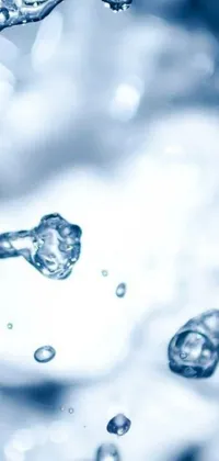 This phone live wallpaper features a close-up shot of water pouring from a faucet