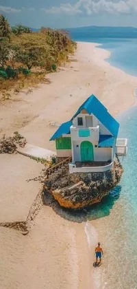 Experience the serene beauty of a house on the beach with this captivating live wallpaper