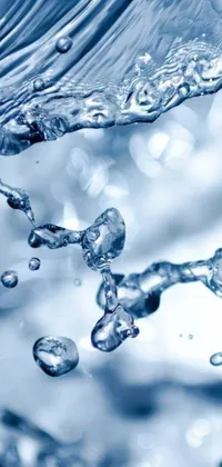 This live wallpaper features a close up of water pouring from a faucet in crystal clear blue color
