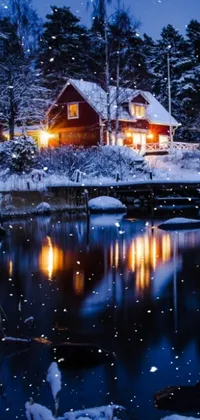This phone live wallpaper features the beauty of winter, with a charming house sitting next to a snow-covered body of water