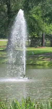 This stunning live wallpaper features a fire hydrant spewing water into a beautiful pond surrounded by lush trees