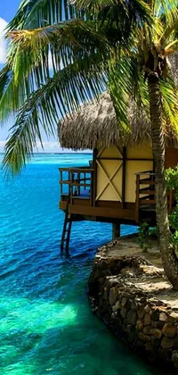 This lively phone wallpaper features a charming tropical hut on a beautiful beach with a shimmering body of water in the background
