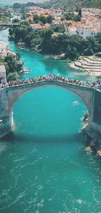 This mobile live wallpaper showcases a vibrant image of a bridge with a group of people standing on top