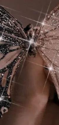 This phone live wallpaper showcases a close-up shot of a stunning dress with a butterfly, providing a magical tone