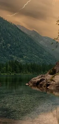 This phone live wallpaper features a breathtaking natural scene, showcasing a large body of water and a mountain in the background