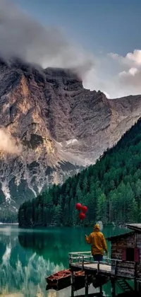This live wallpaper for your phone displays a serene image of a dock in front of a mountain, complete with a gorgeous forest in the distance