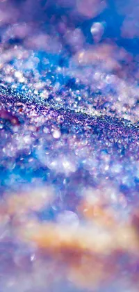 This phone live wallpaper features a captivating close-up of a purple and blue pointillism background