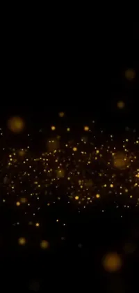 This phone live wallpaper features stunning gold sparkles set against a black background, creating an enchanting effect that is sure to captivate anyone who sees it
