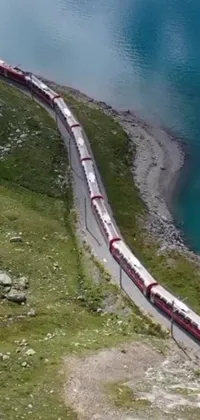 This live wallpaper features a stunning view of a long train traveling on a steel track, meandering through the serene landscape of the Swiss Alps
