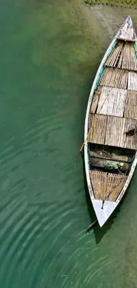 This phone live wallpaper features a bamboo boat floating on calm water