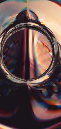 This phone live wallpaper showcases a captivating image of a glass with a ring, designed in an abstract illusionism style