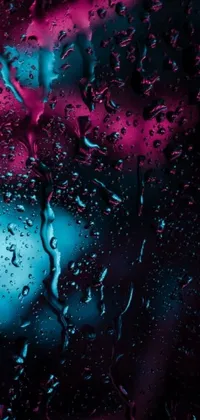 This live phone wallpaper is a stunning close-up of water droplets on a window