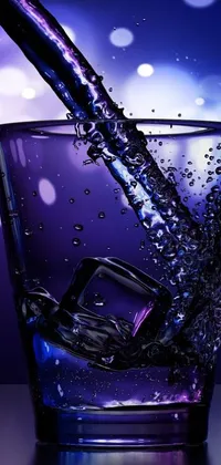 This digital phone live wallpaper features a glass filled with water on a tabletop, with blue and purple lighting and glinting particles of ice