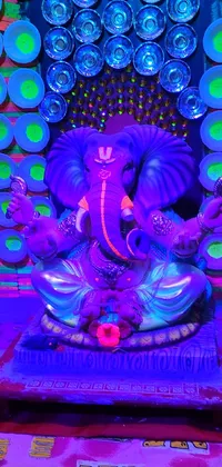 This live wallpaper features an intricately crafted statue of an elephant, symbolizing wisdom, strength, and fortune while surrounded by a vividly colored hologram