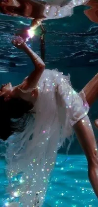 A serene phone live wallpaper featuring a woman in a flowing, white dress, floating in a still pool