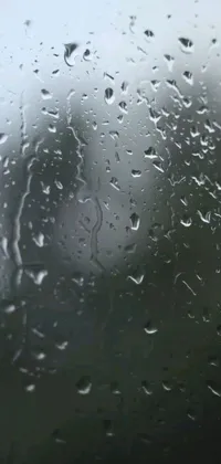 This exquisite phone live wallpaper features a high-definition close-up of a raindrop-covered window