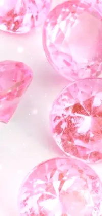 This phone live wallpaper features a stunning collection of pink diamonds on a bright white background
