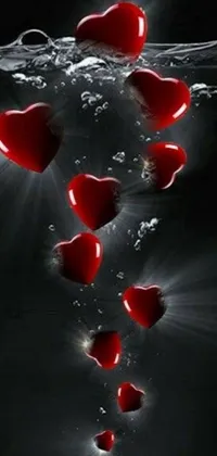 This phone live wallpaper features a beautiful design of red hearts floating in water, creating a romantic and sentimental feel