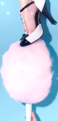 This phone live wallpaper showcases a unique image of a woman standing on top of a large fluffy ball in a surrealistic setting
