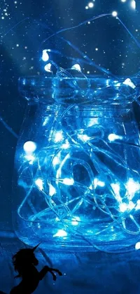 Get lost in the enchanting glow of this phone live wallpaper featuring a glass jar filled with glowing fairy lights