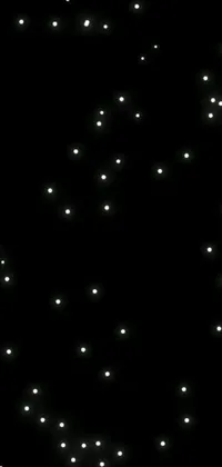 This phone live wallpaper features tiny white dots that transform into mesmerizing glowbugs against a sleek black background