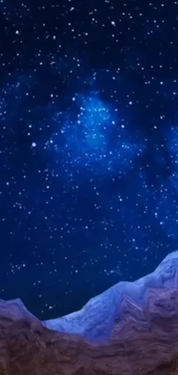 This phone live wallpaper depicts a captivating night sky filled with numerous stars against a striking mountain backdrop