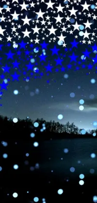 This live wallpaper features a snowy plain adorned with sparkling stars in a dark blue-black scene