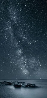 This beautiful mobile live wallpaper features a serene and calming night sky above a tranquil body of water