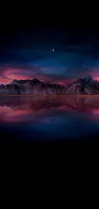 This phone live wallpaper showcases a picturesque body of water with mountains in the distance, set against a moonlit purple sky