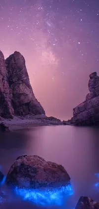 This stunning phone live wallpaper features a serene body of water with two rocks sitting atop it