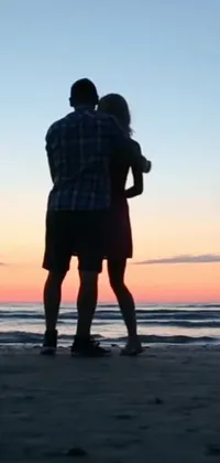Get lost in the serene scene of a romantic beach sunset with this stunning phone live wallpaper