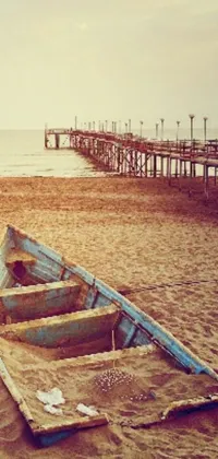 Experience the charm of vintage with this romantic phone live wallpaper featuring an antique boat resting on a sandy beach