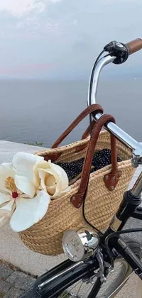 This live phone wallpaper features a vintage bike with a flower-filled basket, set against a sea backdrop