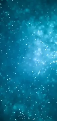 This phone live wallpaper features a digital art image of snowflakes over a blue background, complemented with floating dust particles and a glitter GIF effect