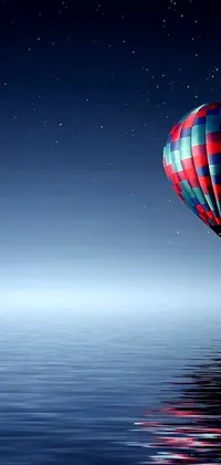 This stunning phone live wallpaper showcases a hot air balloon floating peaceful above a body of water