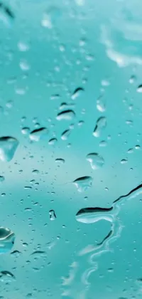 This phone live wallpaper features an hyperrealistic image of water droplets on a windshield animated with 3D fluid simulation render