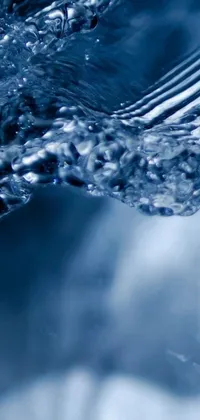 This mobile live wallpaper showcases a stunning and serene close-up of water with various bubbles floating to the surface and popping