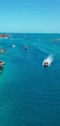 Enjoy an island escape with this phone live wallpaper depicting boats on the water in the Bahamas