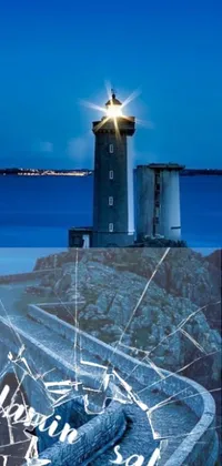 This phone live wallpaper features a mesmerizing image of a lighthouse on a rocky cliff beside the ocean, surrounded by a scenic city landscape