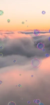This phone live wallpaper showcases a collection of soap bubbles floating against a light pink sunset sky