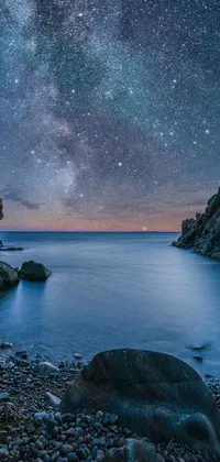 Experience the serene beauty of a rocky evening beach with this stunning phone live wallpaper